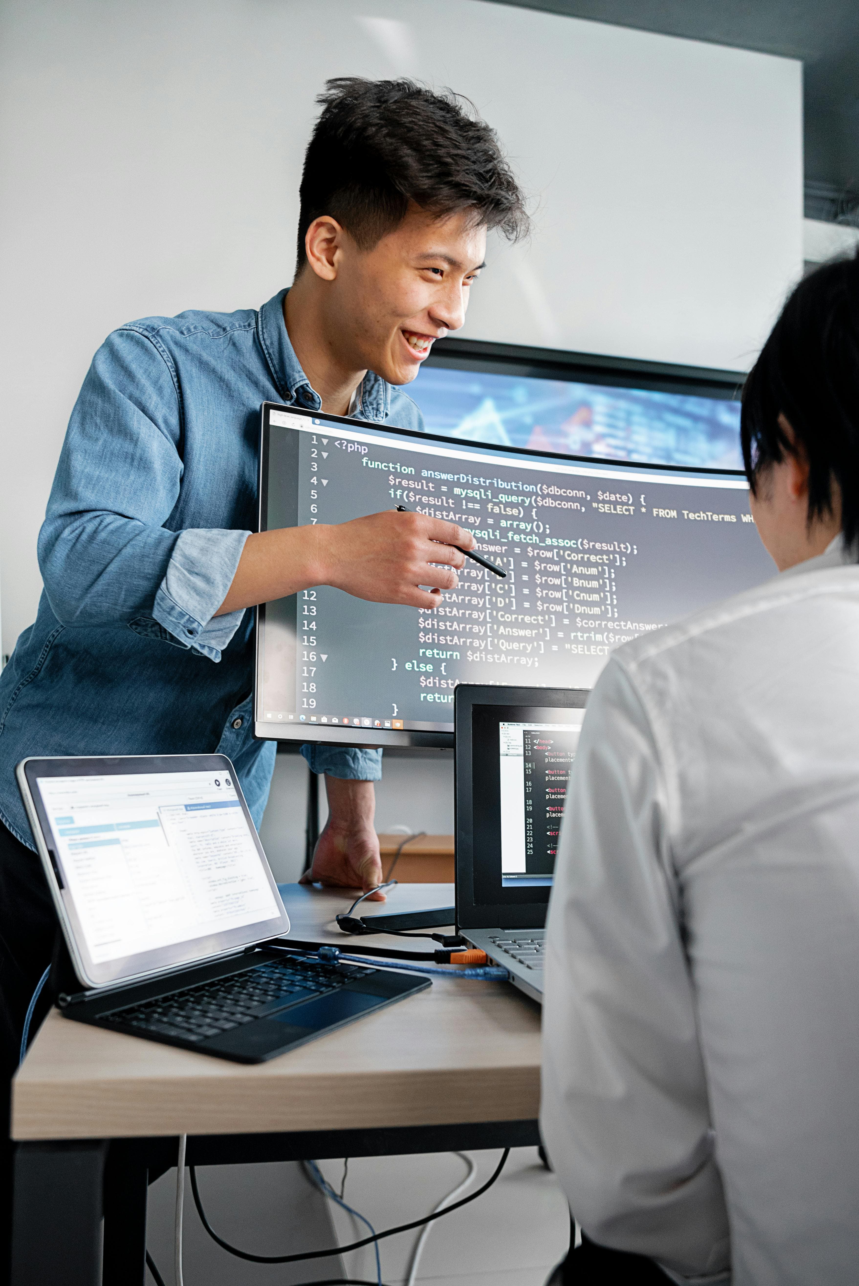 Students at laptops in a coding workshop